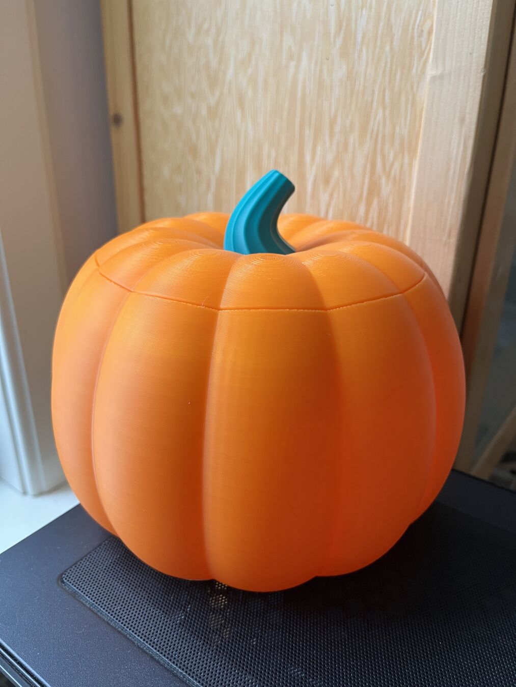 A bowl in the shape of a pumpkin with the lid closed