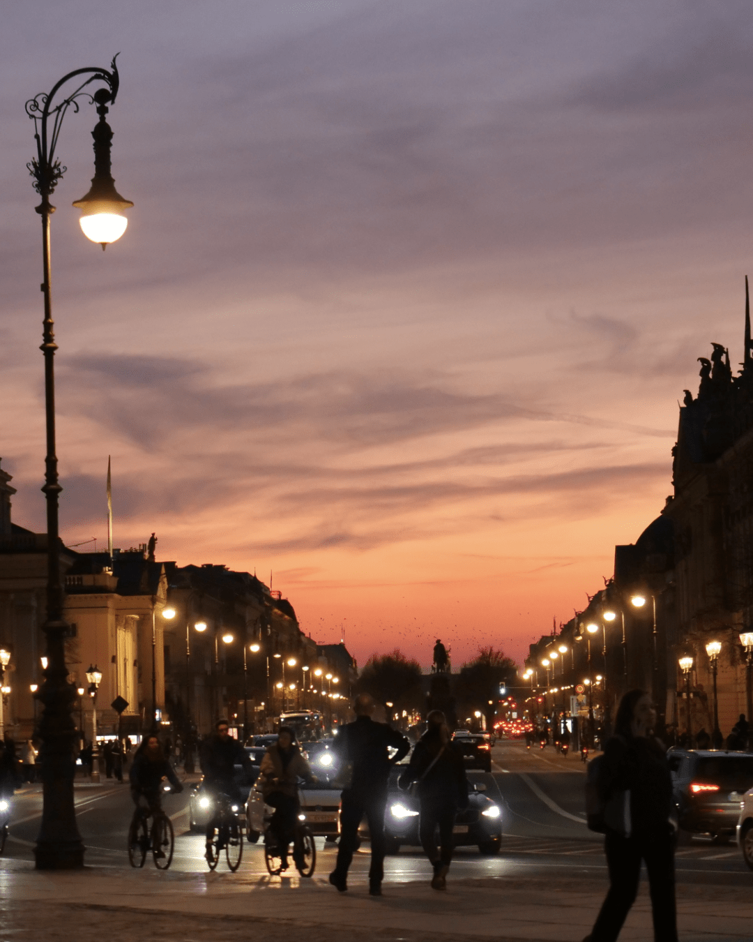 night long exposure of the light illuminating a street with bikes and cars passing